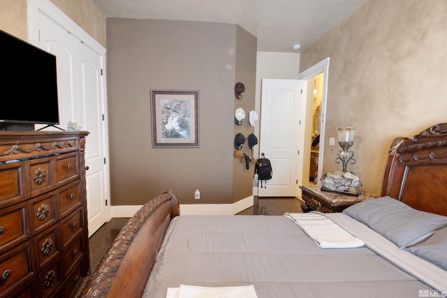 bedroom with dark hardwood / wood-style flooring