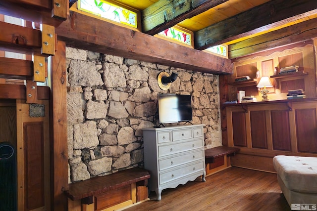 interior space featuring beam ceiling and hardwood / wood-style floors
