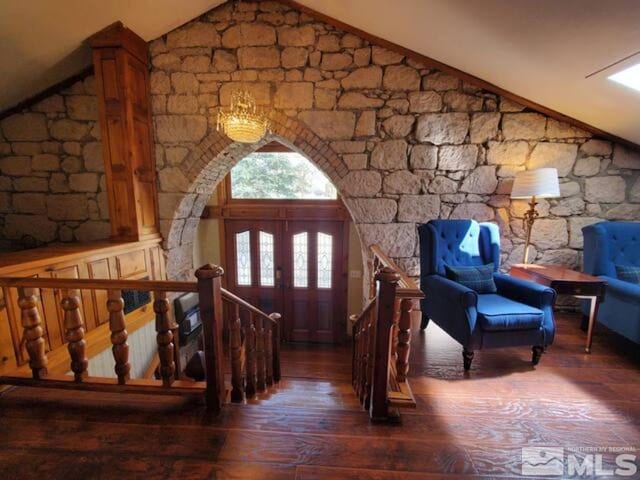 entrance foyer with lofted ceiling and dark hardwood / wood-style floors
