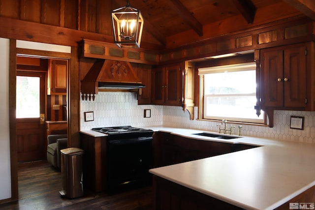 kitchen with vaulted ceiling with beams, sink, custom exhaust hood, hanging light fixtures, and black / electric stove