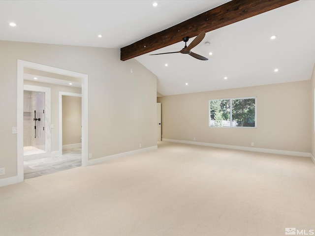 spare room with ceiling fan, lofted ceiling with beams, and light carpet