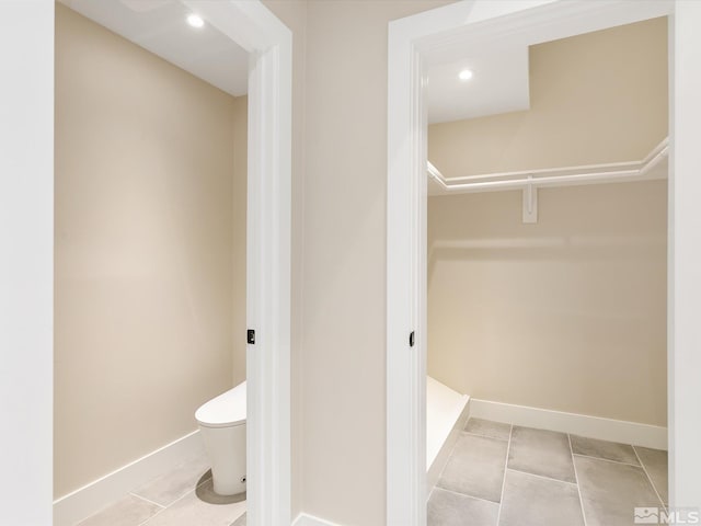 bathroom featuring tile patterned floors and toilet