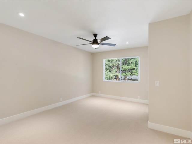 carpeted empty room featuring ceiling fan