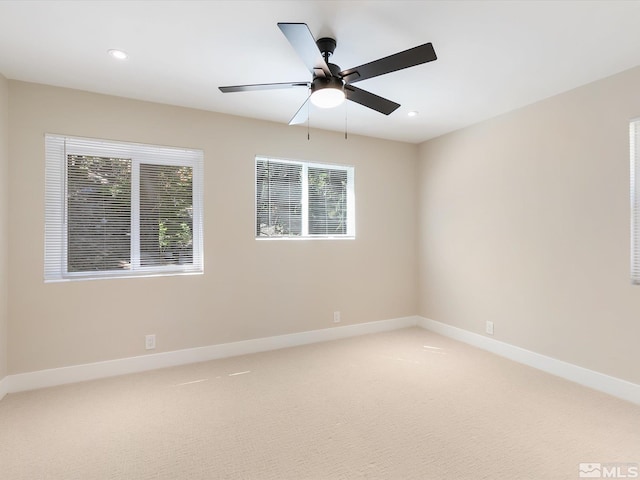 carpeted empty room featuring ceiling fan