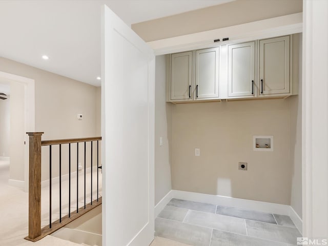 washroom with washer hookup, cabinets, light carpet, and hookup for an electric dryer