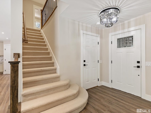 entryway featuring a notable chandelier and hardwood / wood-style floors