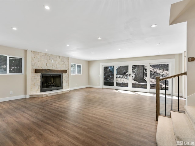 unfurnished living room featuring a fireplace and hardwood / wood-style flooring