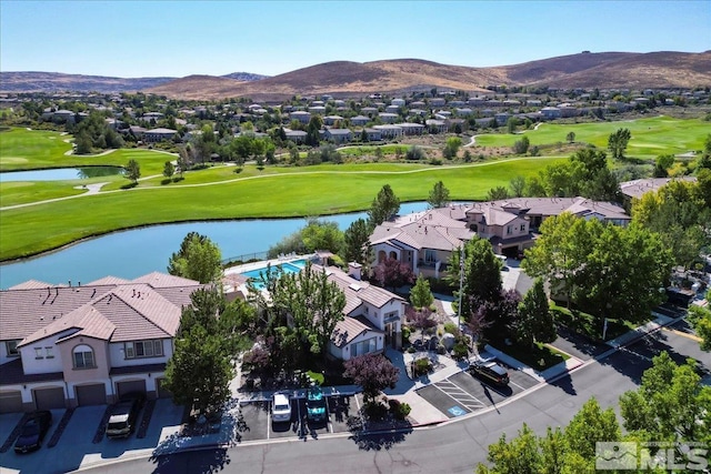 aerial view with a residential view, a water and mountain view, and view of golf course