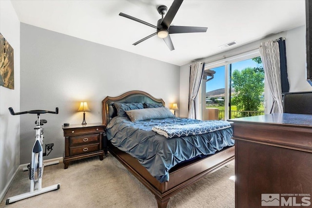 bedroom featuring light carpet and ceiling fan