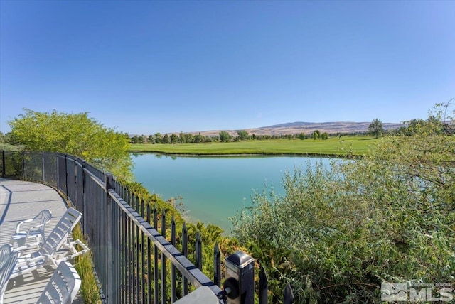 balcony featuring a water and mountain view