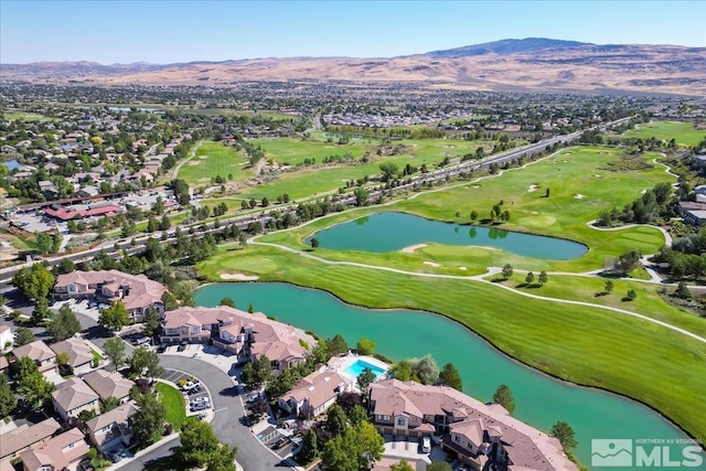 birds eye view of property featuring view of golf course, a residential view, and a water and mountain view