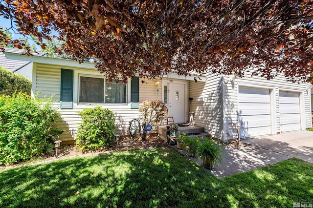 view of front of property with a garage and a front yard