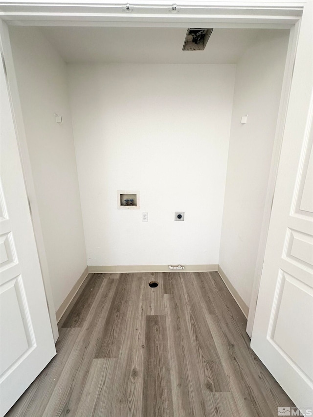 clothes washing area featuring hookup for an electric dryer, hardwood / wood-style flooring, and washer hookup