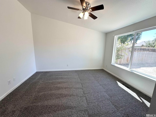 empty room with ceiling fan and carpet