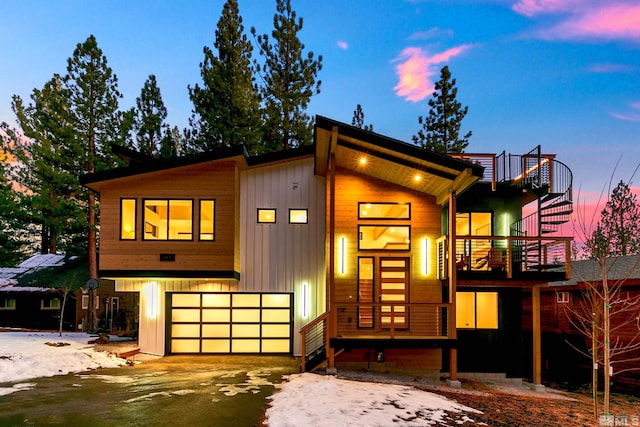 view of front of house with a garage, driveway, and a balcony