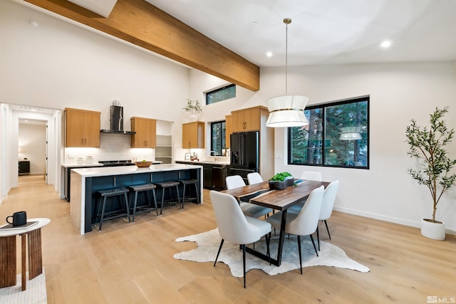 dining room featuring high vaulted ceiling, recessed lighting, baseboards, beam ceiling, and light wood finished floors