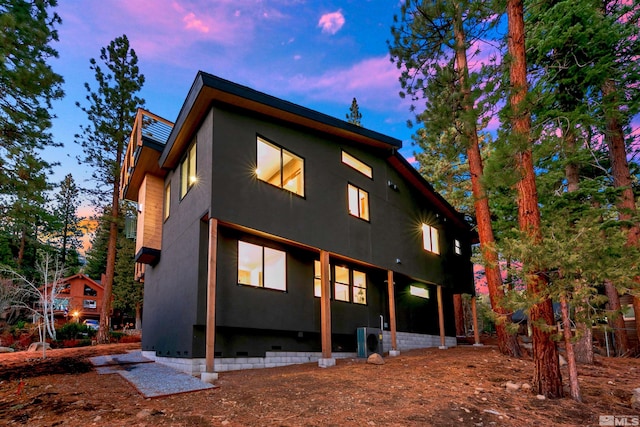 back of property featuring stucco siding