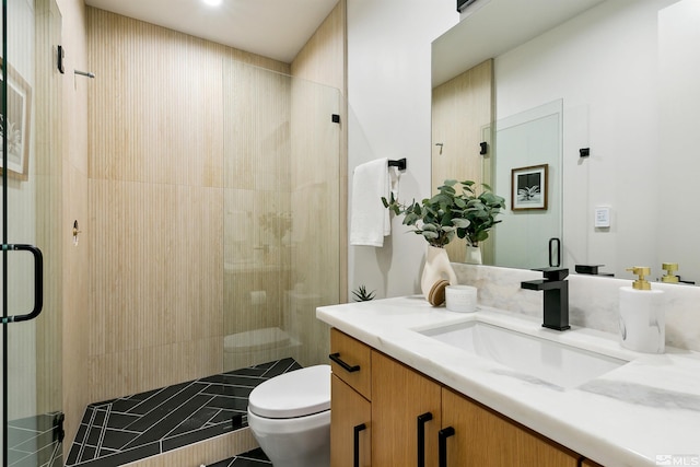 full bath featuring vanity, toilet, and a shower stall