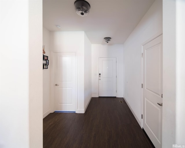 corridor featuring dark hardwood / wood-style flooring