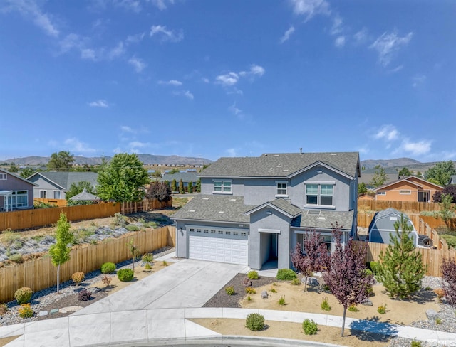 front of property featuring a garage and a mountain view