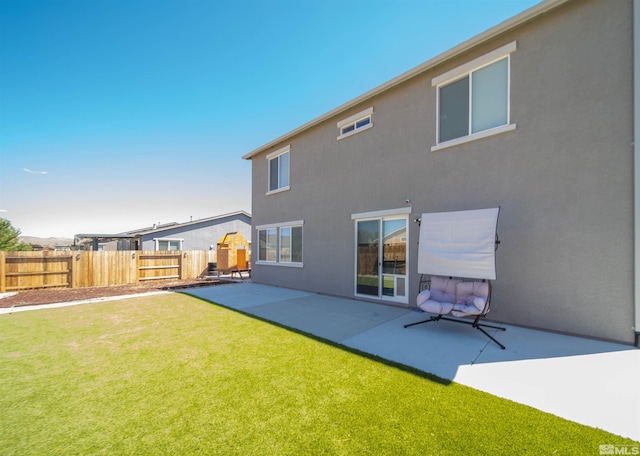 back of house featuring a patio and a lawn