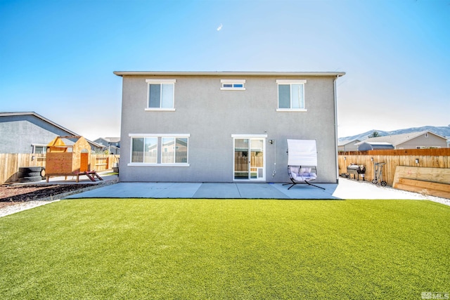 rear view of house featuring a patio area and a yard