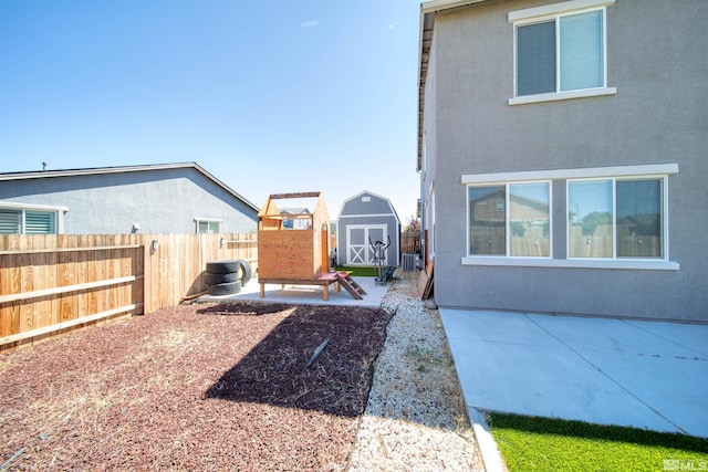 view of yard featuring central air condition unit, a patio area, and a storage unit