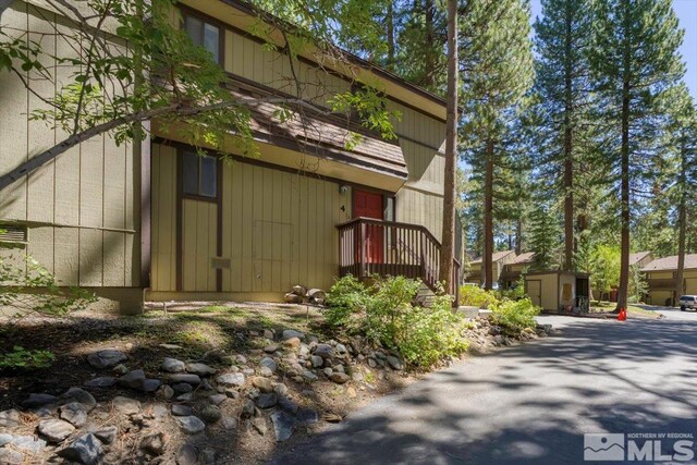 view of property exterior featuring a storage unit