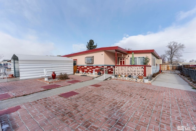 back of property with fence and stucco siding