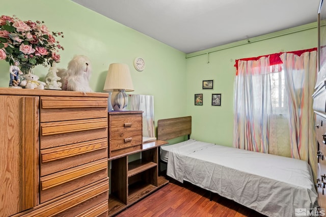 bedroom with dark wood-style floors