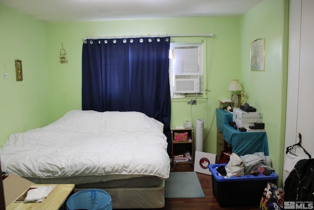 bedroom featuring cooling unit and wood finished floors