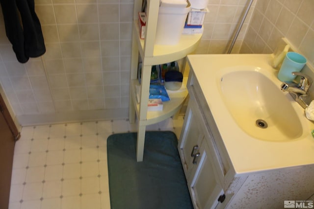 bathroom featuring tile walls and vanity