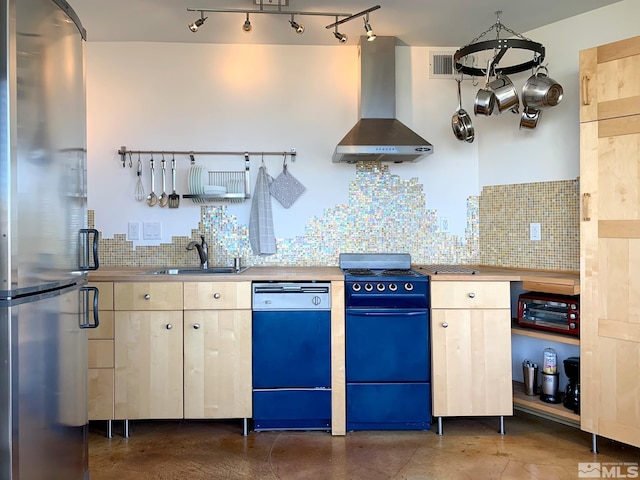 kitchen featuring tasteful backsplash, wall chimney exhaust hood, dishwasher, stainless steel refrigerator, and sink