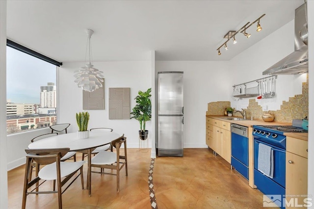 kitchen featuring sink, dishwasher, wall chimney range hood, stainless steel fridge, and range