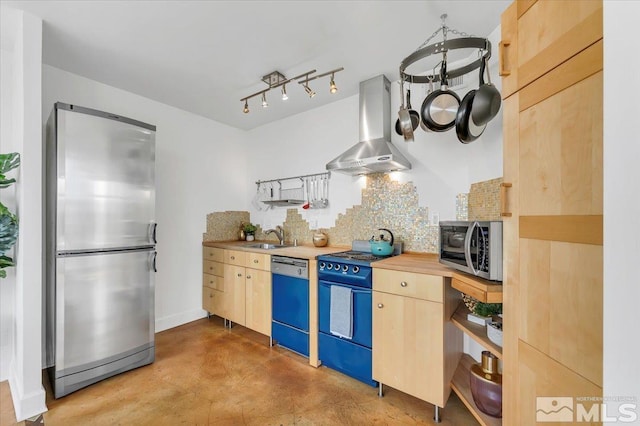 kitchen featuring appliances with stainless steel finishes, backsplash, light brown cabinets, and range hood