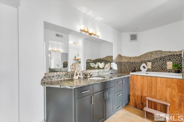 full bathroom with tasteful backsplash, vanity, and visible vents