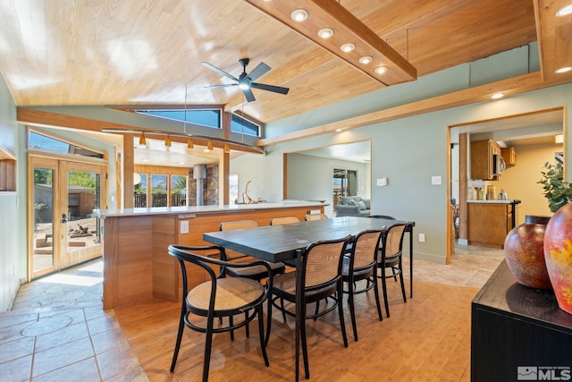 dining room with light tile patterned flooring, french doors, ceiling fan, wood ceiling, and lofted ceiling