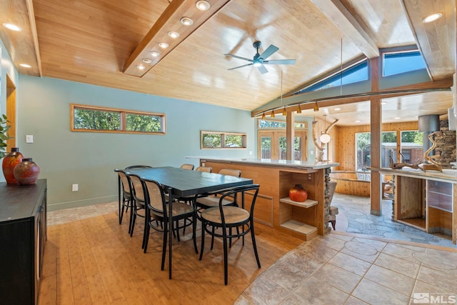 dining space featuring wooden ceiling, baseboards, light wood finished floors, and beam ceiling