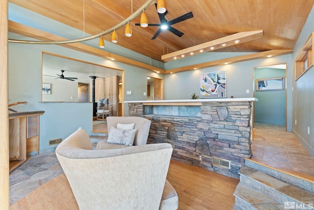 interior space with ceiling fan, visible vents, light wood-type flooring, and wood ceiling