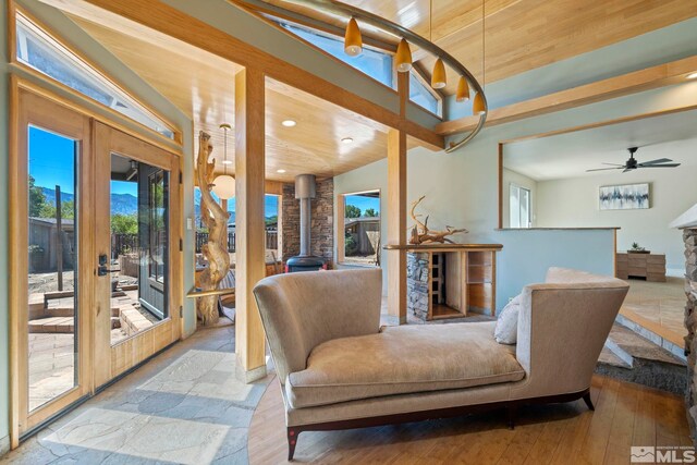 sunroom with wood ceiling and a wood stove