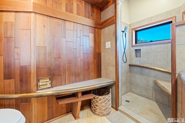 bathroom with tiled shower and toilet