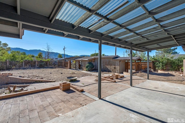 view of patio with a fenced backyard and a mountain view