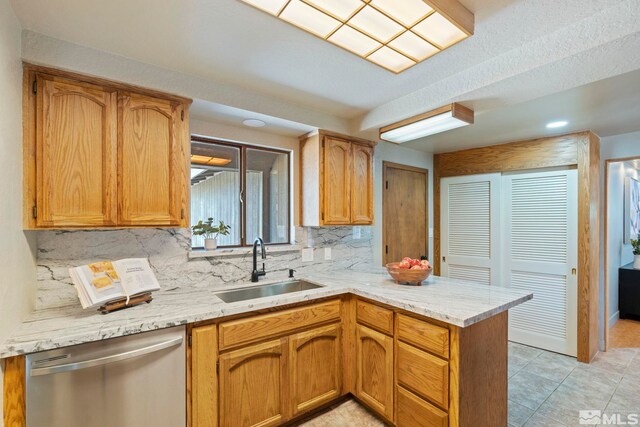 kitchen with appliances with stainless steel finishes, light tile patterned flooring, decorative backsplash, and light stone countertops