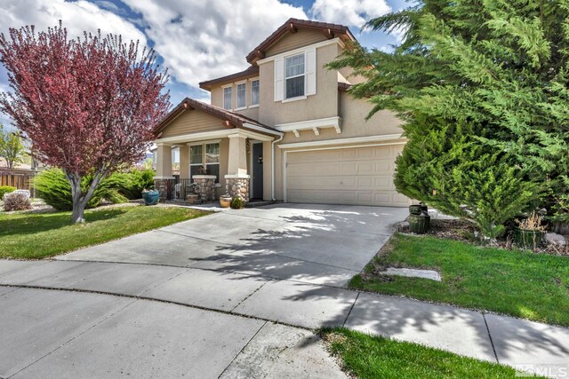 view of front of property featuring a garage and a front yard