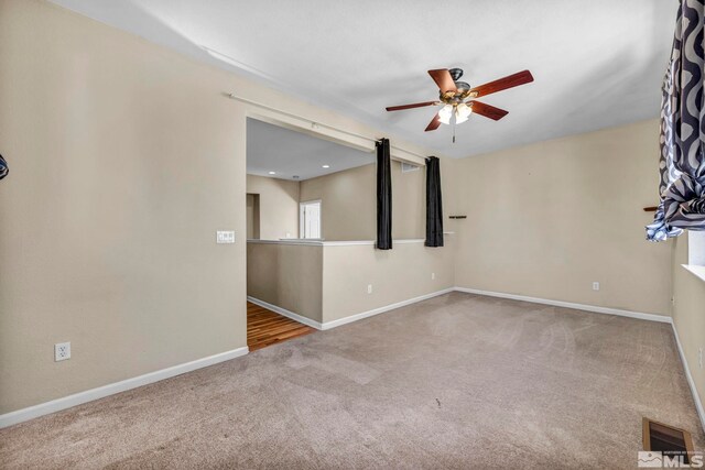 empty room with carpet floors and ceiling fan