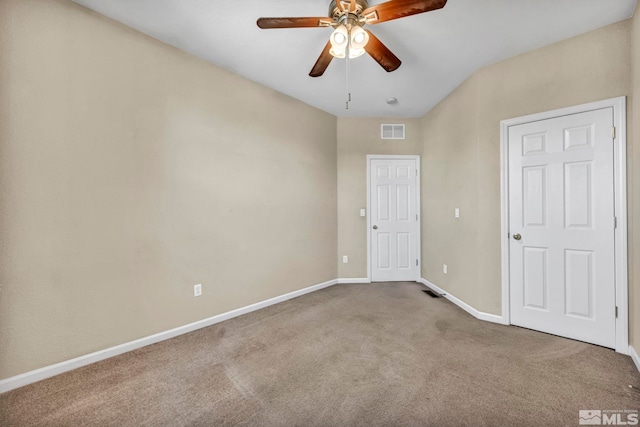 carpeted spare room with ceiling fan