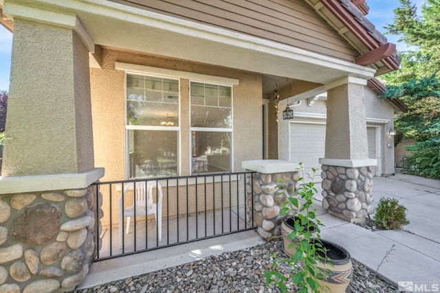 entrance to property featuring concrete driveway and stucco siding