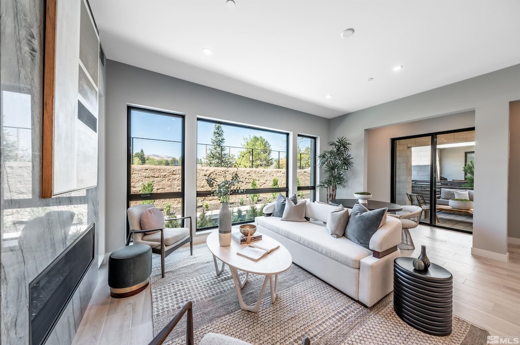 living area featuring light wood-style flooring and recessed lighting