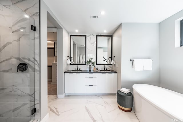 bathroom with tile patterned floors, separate shower and tub, and double vanity