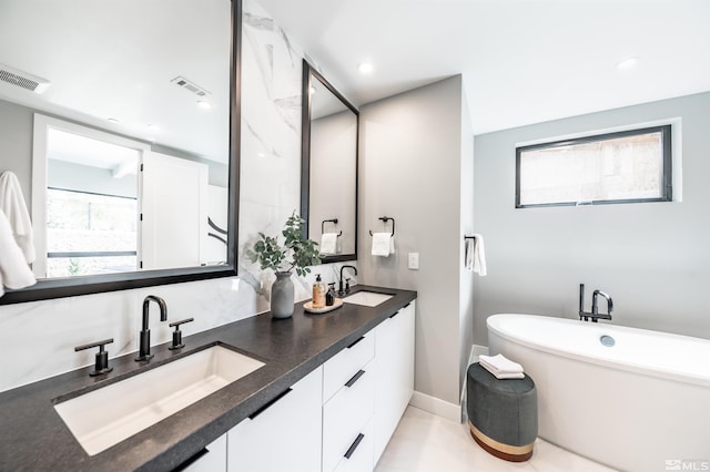 bathroom with tile patterned flooring and dual bowl vanity